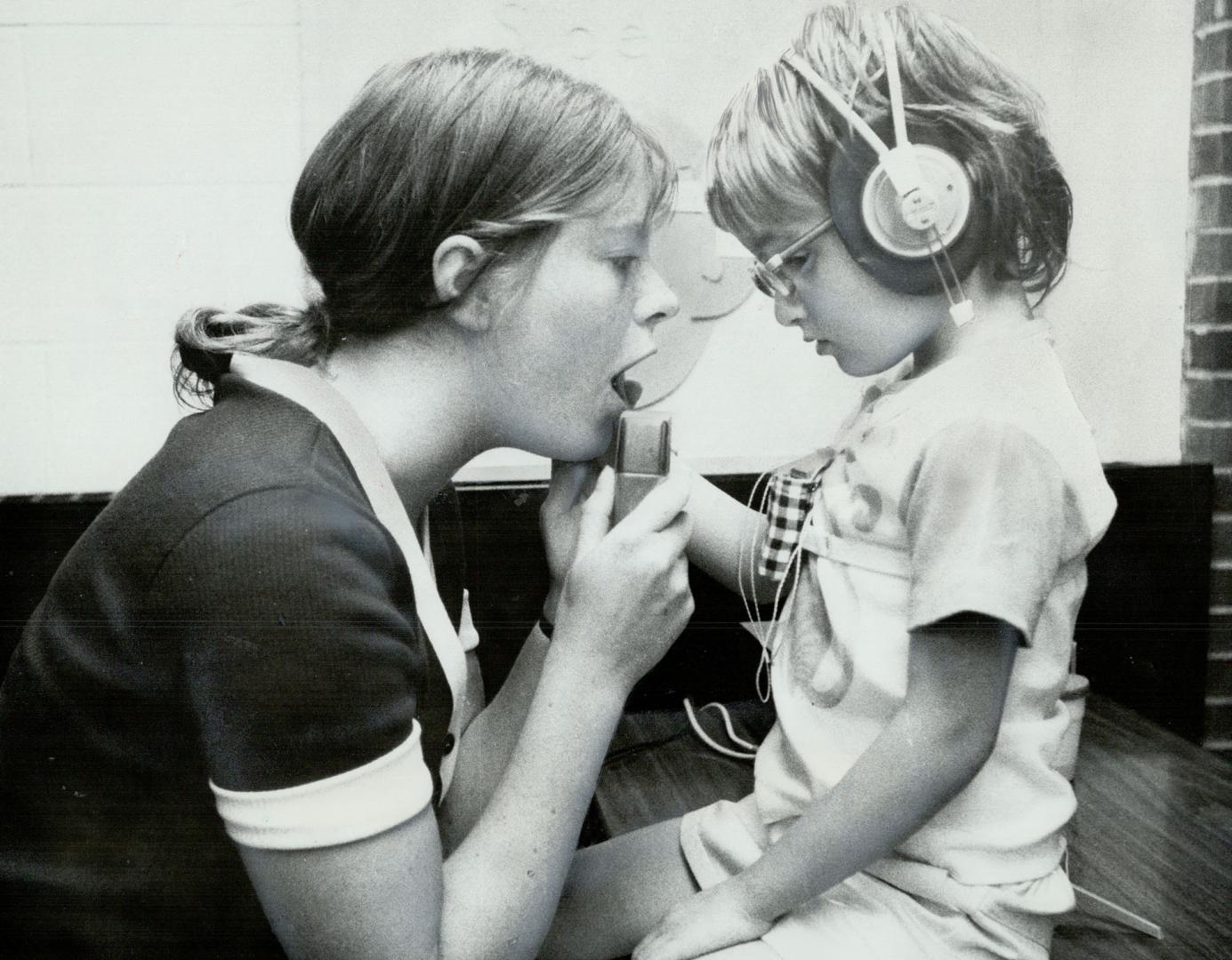 Teacher hazel Eastwood gives a speech lesson to Christine Valecourt, 6, who is both blind and deaf