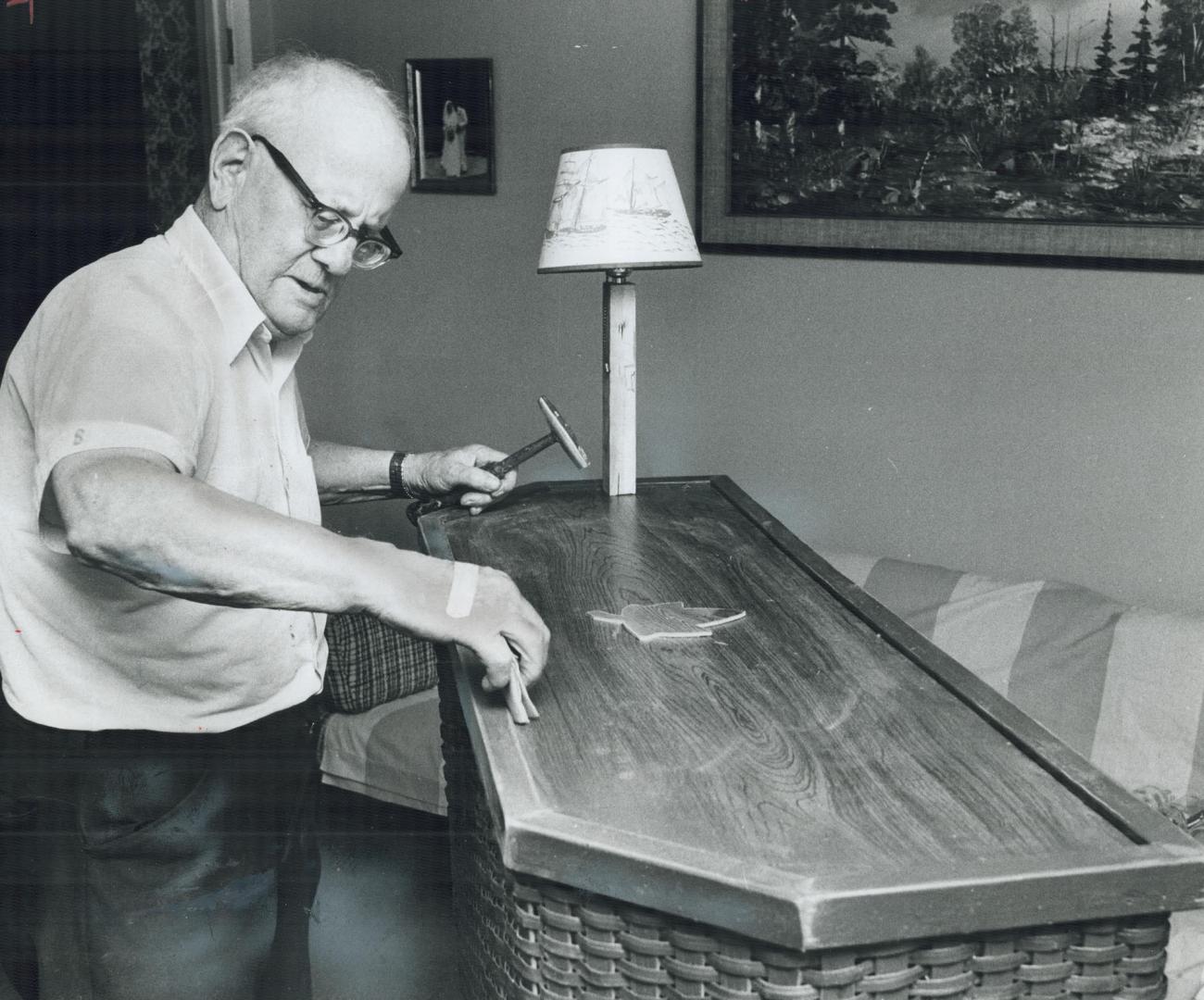 Blind carpenter Alfred Tout, sanding down a bar he built for his daughter, doesn't let his handicap bother him