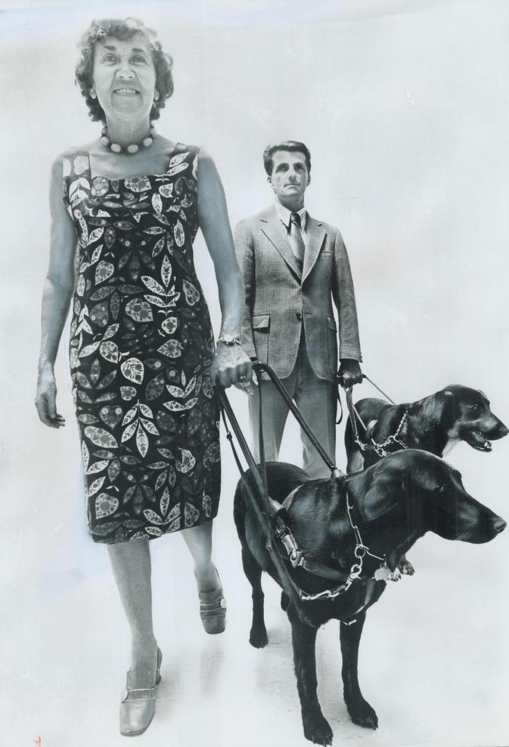 Seeing-eye dogs Boz and Duke go through their paces with their owners, Betty Jane Leadbeater and Ken London