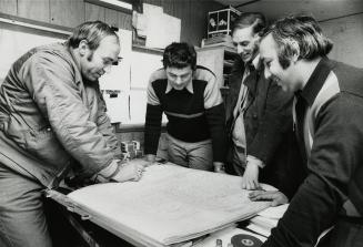 Lee Ramage the pilot points the different pieces of the mast for the antennae as Paul Mitchell foreman, Stu Eccles manager and on the right foreground Bob Bronstein look on