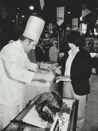 Serving up: Bittner company chef Klaus Theyer carves a slice of beef for visitor Bonnie Meisel Cox to sample