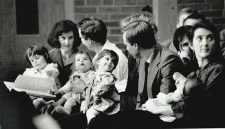 Romanian Orphans: Nicoleta Graff, left, Mark and Gillian Davenport and Heidi Meincke sit with parents at a Willowdale church service yesterday