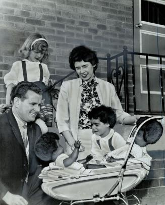 They point the way, Mr. and Mrs. Carl Devries are shown with their daughter Linda (left) and their adopted child Cathy, who is part Negro