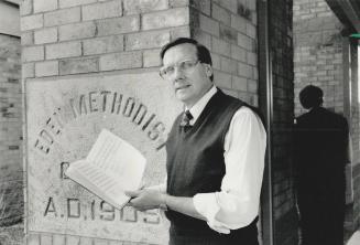 Hym sing: Reverend John Ambrose of Eden United Church prepares for a hymn signing fundraising marathon in which he'll be signing 1,000 hymns non-stop to help put a dent in the church's debt