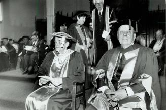 Two feted: Rev. Leonard Boyle, left, who oversees the Vatican's archives, and realtor Joseph J. Barnicke are given honorary doctorates yesterday from St. Michael's College