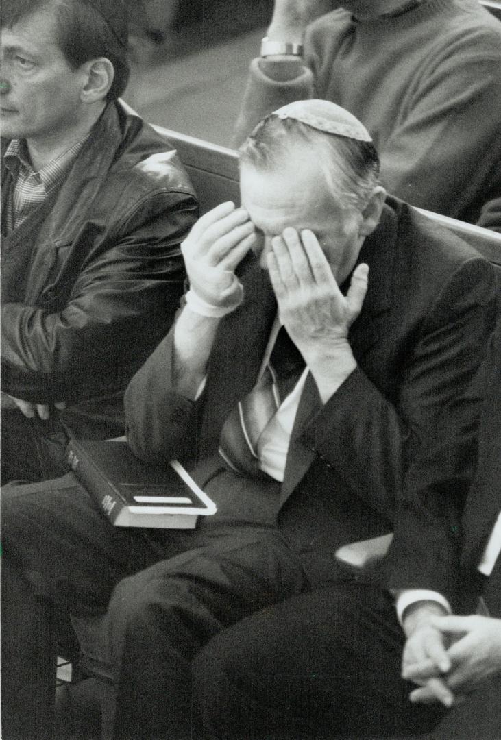 Private Moment: Rabbi Benjamin Freedberg prays with about 3,500 others who packed Metro's Beth Tzedec Synagogue yesterday in support of Israel after Iraqi attacks