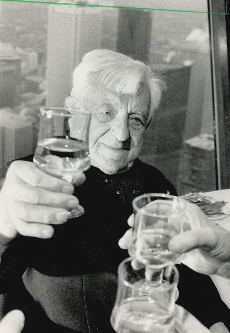 Milestone: Very Rev. Stepan Gauk of Oshawa, a Ukrainian Catholic Priest, is toasted by well-wishers yesterday as he celebrates his 100th birthday at the CN Tower