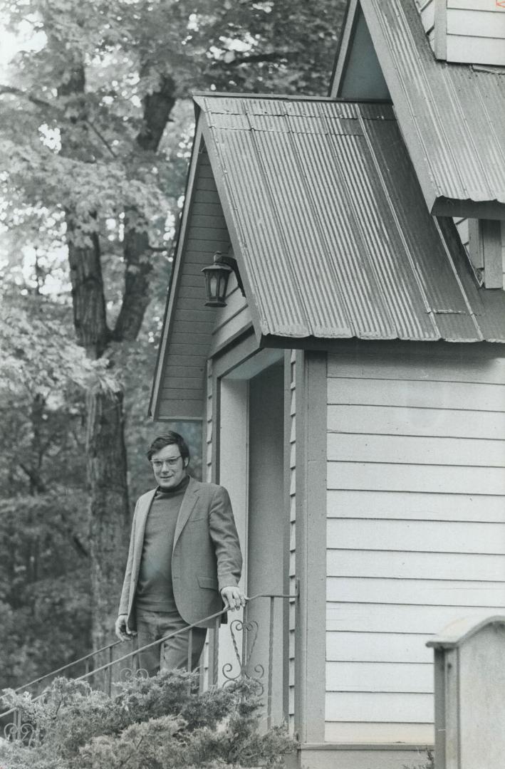 Rev. Peter Hill in front of Emmanuel Anglican Church, He also teaches at St. Joseph's High School and coaches athletics