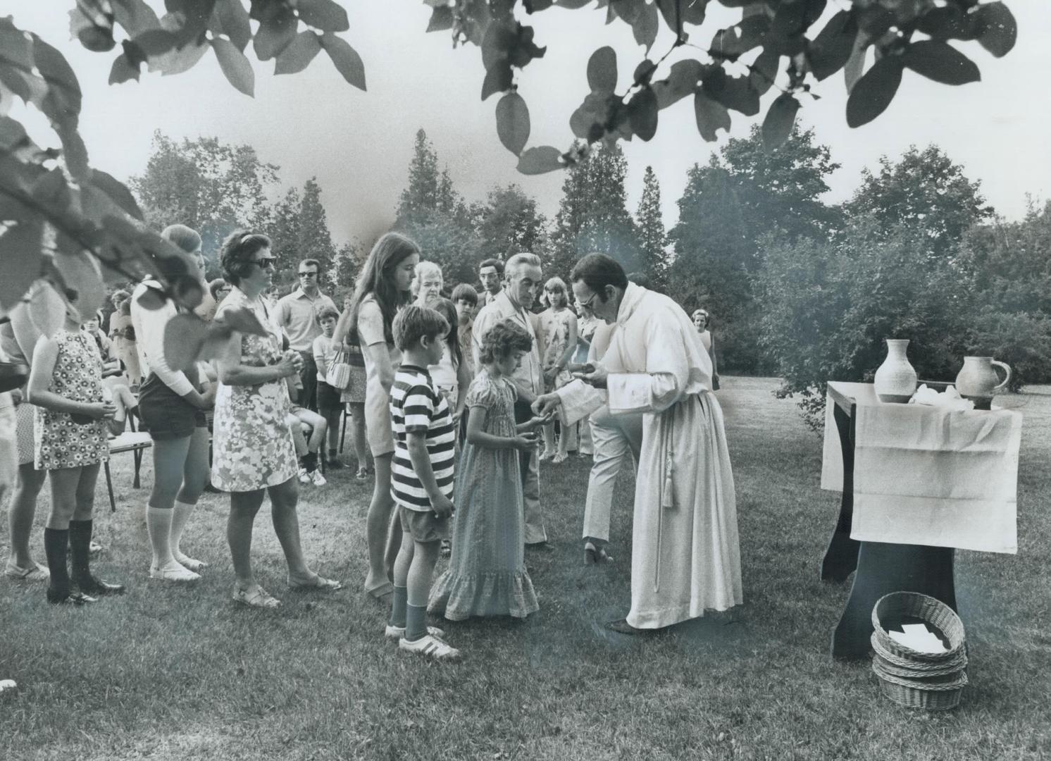 Mass is Celebrated Outdoors by Rev