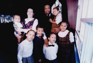 Growing family: Rev. Ron Jones, holding Yvonne, 3, and wife Liz, holding Ron Jr., 5 1/2 months, stand in Cooksville church with, from left, Elizabeth,(...)