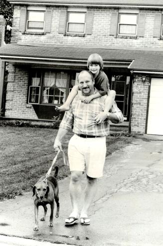 Tenuous future: Rev. Gary Kilgore with daughter Kelsey, 5 1/2, and dog Hannah, outside the house rented for them by the Anglican Diocese of Toronto