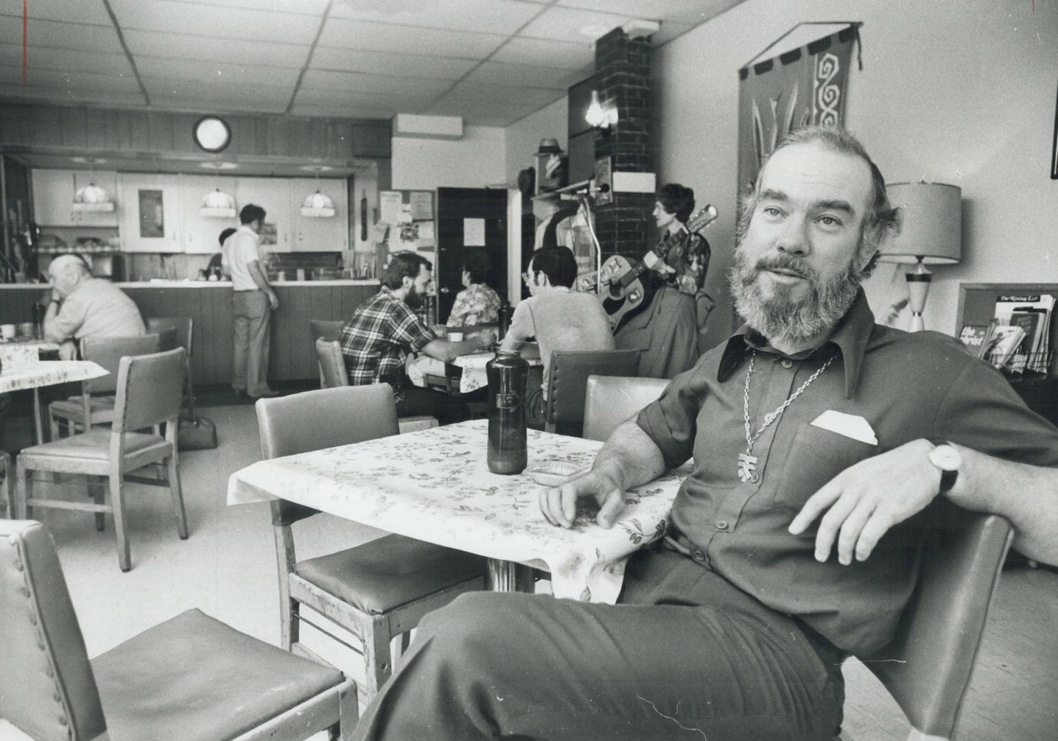 Rev. Joseph MacDonald sits at a table in his Shoppers' Drop-in which provides a haven for lonely or troubled people downtown