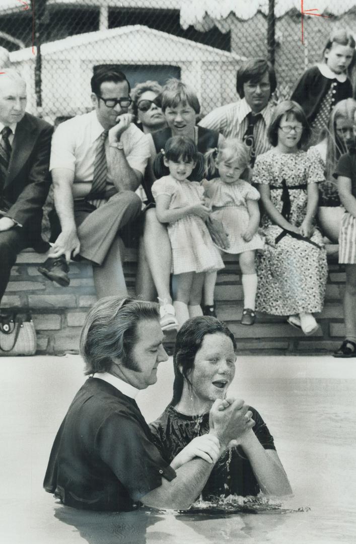 Backyard baptism of Janice Crichton is performed by Rev