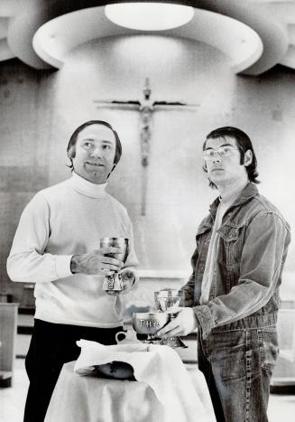 Informal dress worn by Fr. Dick Roach, left, and seminarian Bill Perkins as they prepare mass shows how Jesuit training is moving from academic monasticism to involvement in the world of today