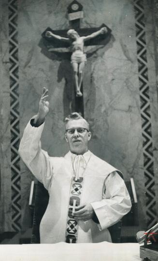 Priest celebrates silent mass. He even dreams in sign language now