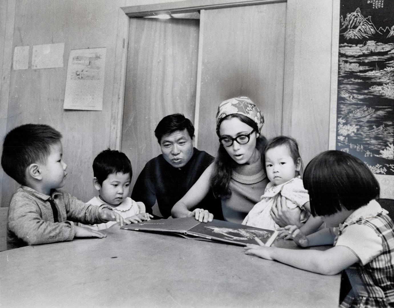 Rev. Louis Tchang and Sylvia Laale with pre-schoolers. They're in nursery in one area of former Cecil St. synagogue