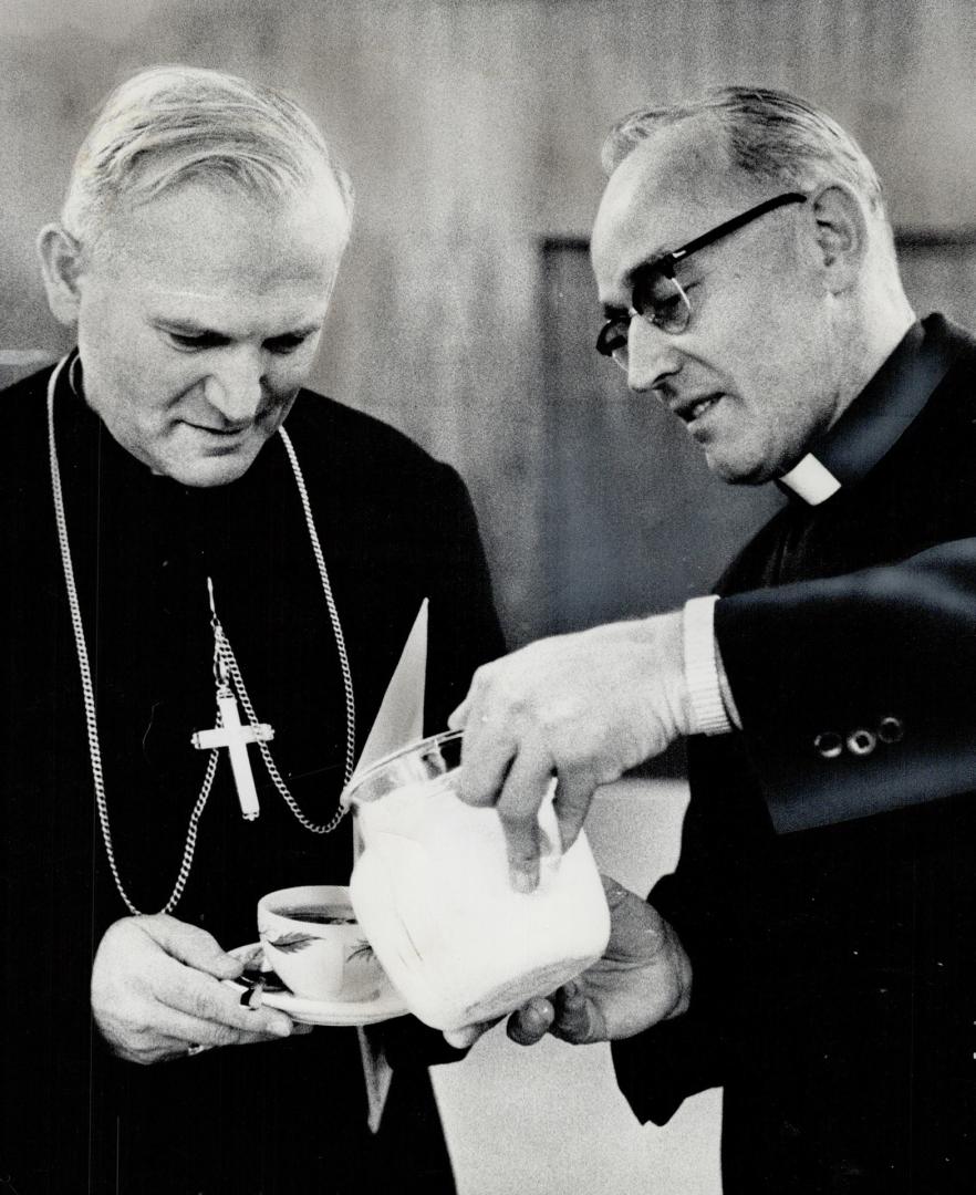 Karol Cardinal Wojtyla, archbishop of Cracow, Poland, takes time out for cup of coffee with host Father Michael Smith, right, in Port Credit last nigh(...)