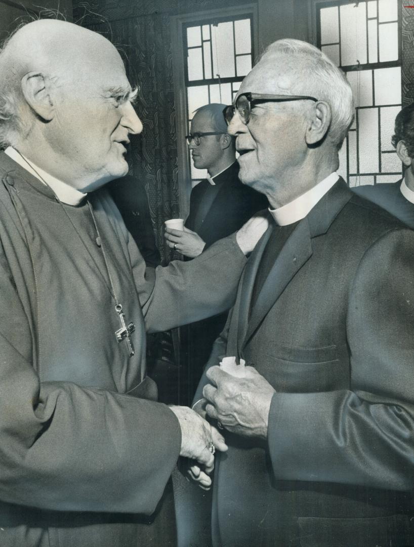 Bishop-to-canon talk. Archbishop of Canterbury, Michael Ramsey (left), chats with Canon Harold Hesketh at the Church of St. Augustine. Ramsey is in Toronto to deliver series of lectures