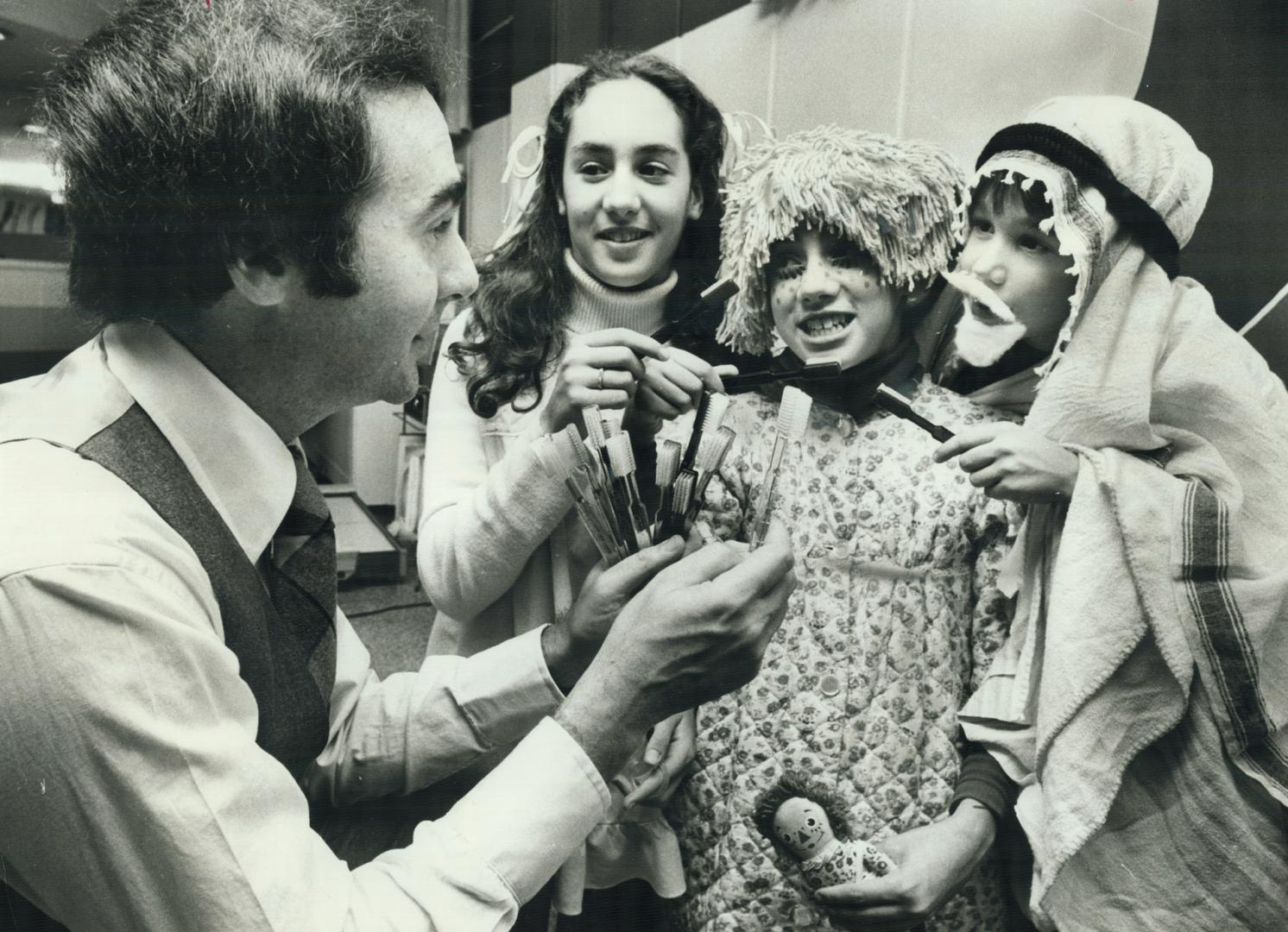 It's a tricky treat that Dr. Samuel M. Green gives out at his house on Hallowe'en - a toothbrush instead of confections. Green is a dentist, so rather(...)