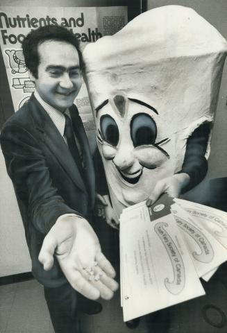 The tooth mascot, who visits Etobicoke libraries and schools to teach dental care, stands with Dr. Sam Green, the borough dental director and founder (...)