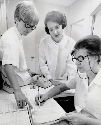 Dr. Cernavskis and her associate, Dr. Sarma Damanis, left, check the office appointment book with secretary-receptionist Veronica Grant. Dr. Cernavski(...)