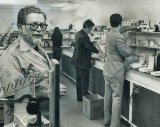 Denturist Ben Sweet (left) stands by yesterday while his clinic, on Eglinton Ave