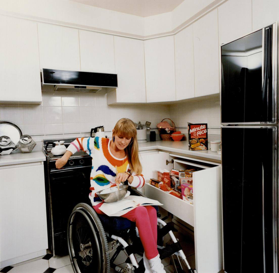 Far left, Wendy Murphy, 24, cooks with the help of front stove dials and lowered cupboard drawers