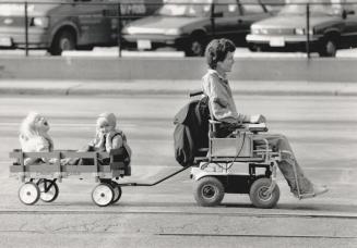 Happy hitch-hikers. Matt Van Geffen tows his daughter, Kari, 4 (at the back of the wagon), and her friend, Leslie Meyers, 3, home along Queen's Quay a(...)