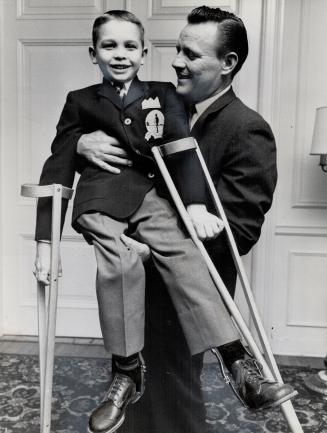 Ralph Houk holds up dinner's symbol, Timmy of 1963