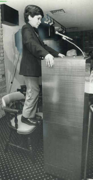 He stands tall: The 1982 Easter Seal Timmy, Reg Topping, stands tall on a chair yesterday at a luncheon in the Hot Stove Lounge to promote Snowarama at Lake Simcoe