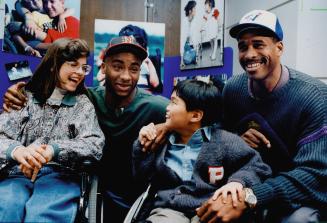 Big night for Timmy and Tammy. The Argonauts' Raghib (Rocket) Ismail and the Blue Jays' Dave Winfield, right, share a laugh with this year's Easter Se(...)