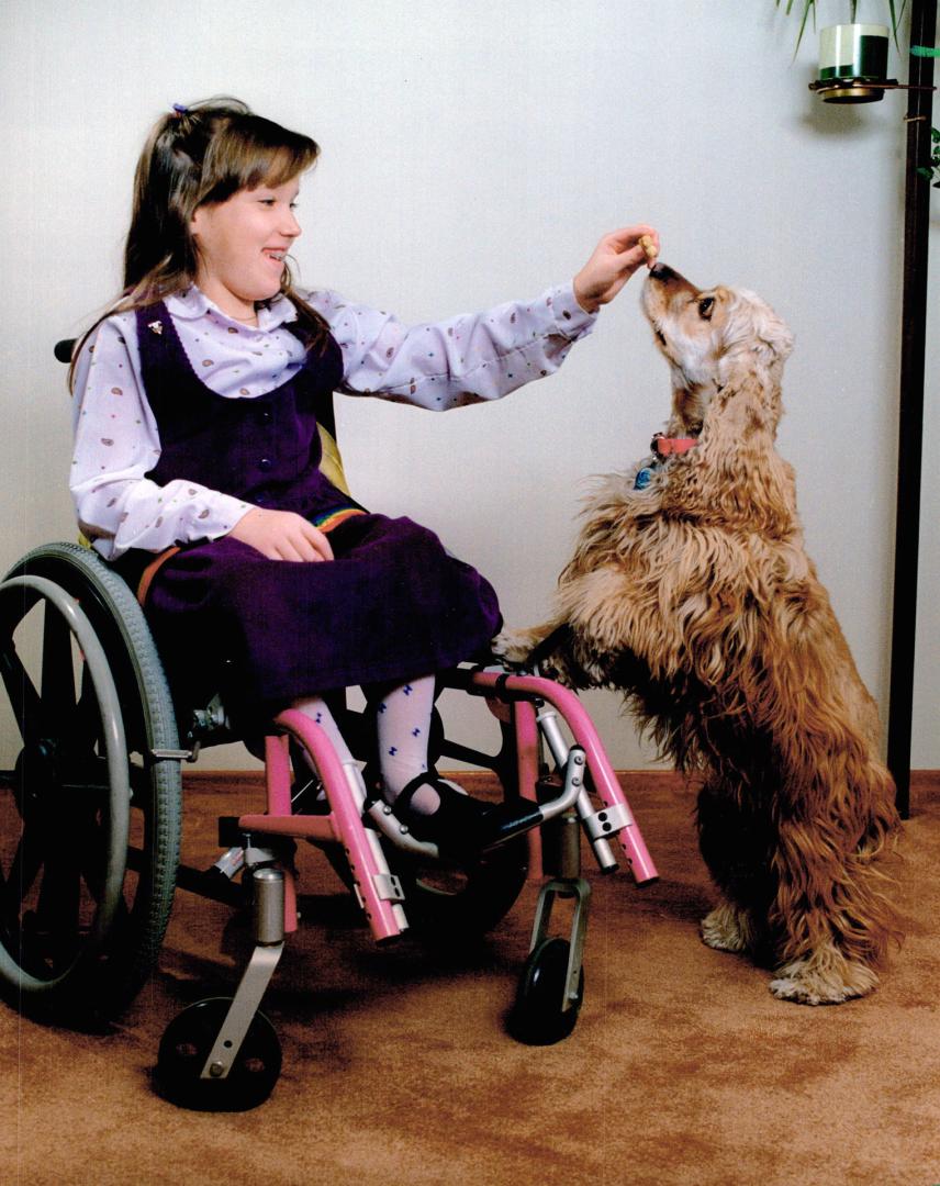 Easter Seal Poster Girl. Sabrina Levear, 8, Easter Seal Tammy for Brampton, rewards her dog, Ginger, with a snack. Her first official duty will be the(...)