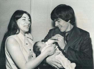 A Deserter from the U.S. Marines, Virgil Ray Polston, 20, helps his wife, Lorraine, feed their new daughter, Tammy Coreen. Polston came in Toronto, go(...)