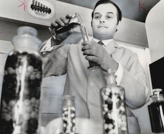 Druggist Raymond Sereda, who helped create the Parcost program, fills a prescription in his pharmacy in Metro