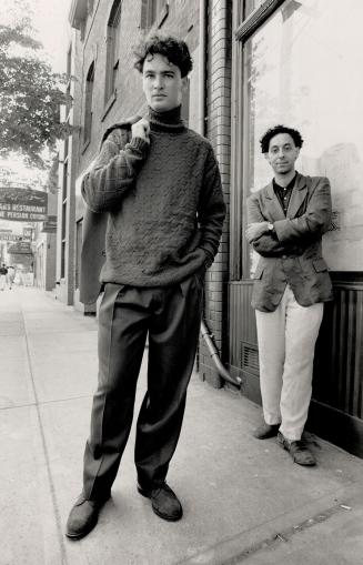 Fall look: Alexander Reda stands with a model weearing his diamond jacquard turtleneck sweater, $250, gabardine trousers, $170, and matching gabardine jacket over the shoulder, $325