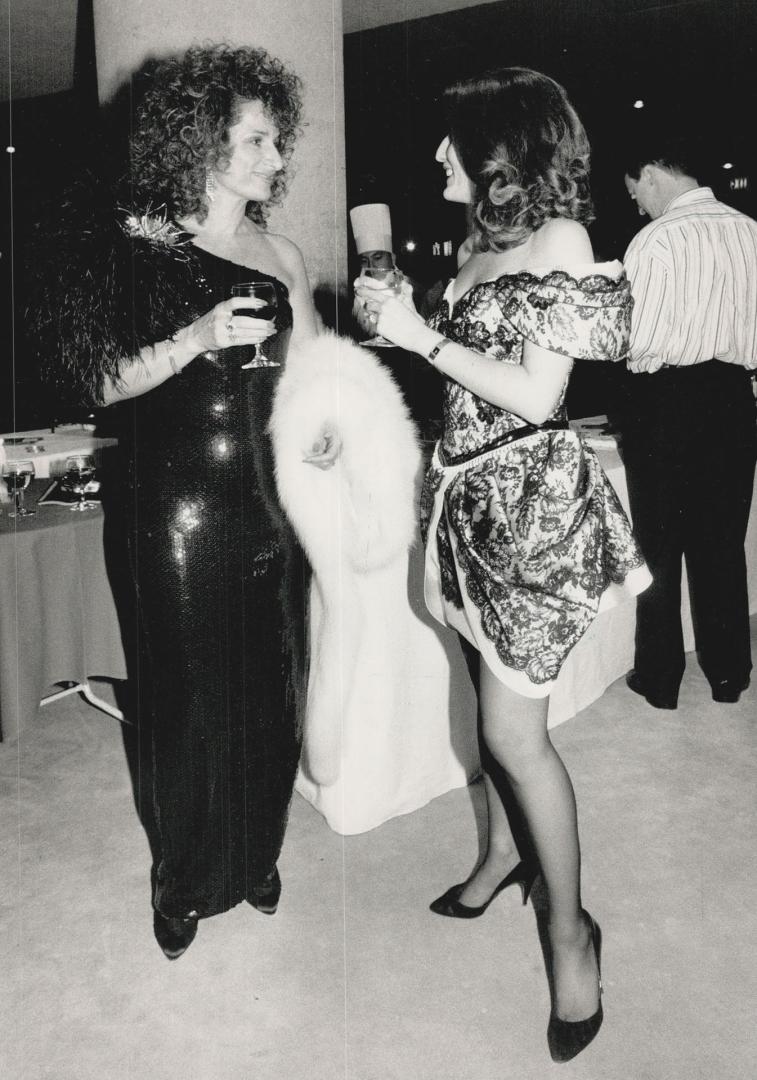 Far left, Rose Carinci, in a black and fox stole, with designer Isabella Briatico in a pearl-adorned dress