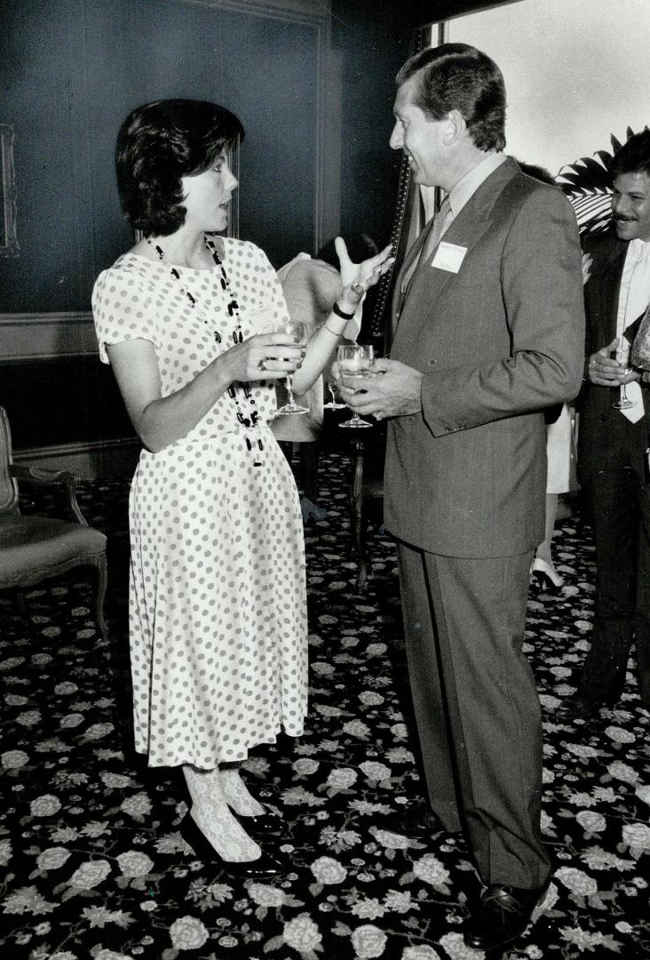 Left, designer Shelly Widmeyer Walsh in dotted dress with antique jet and crystal necklace, a gift from her mother, Michael Williams, manager of The Bay's Mirror Room, sports a snappy pinstripe suit