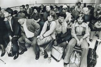 New Canadians who had just arrived from Italy 10 years ago are packed into a corner at Toronto's congested airport