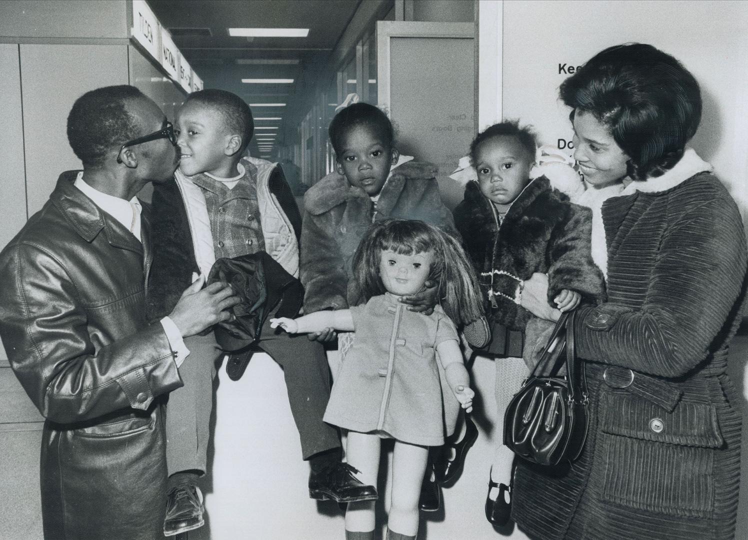 A family's reunited at last. Three wide-eyed Jamaican children flew into Toronto tonight and shyly greeted the parents they'd not seen for months. Mac(...)