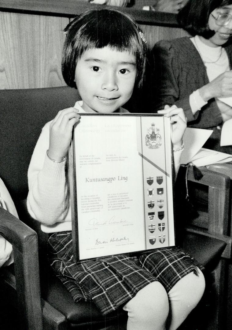 Meet Kuntusangpo Ling, Canadian, Kuntusangpo Ling, 5, the youngest of 62 new Canadians sworn in at a Toronto Citizenship Court yesterday, displays the(...)