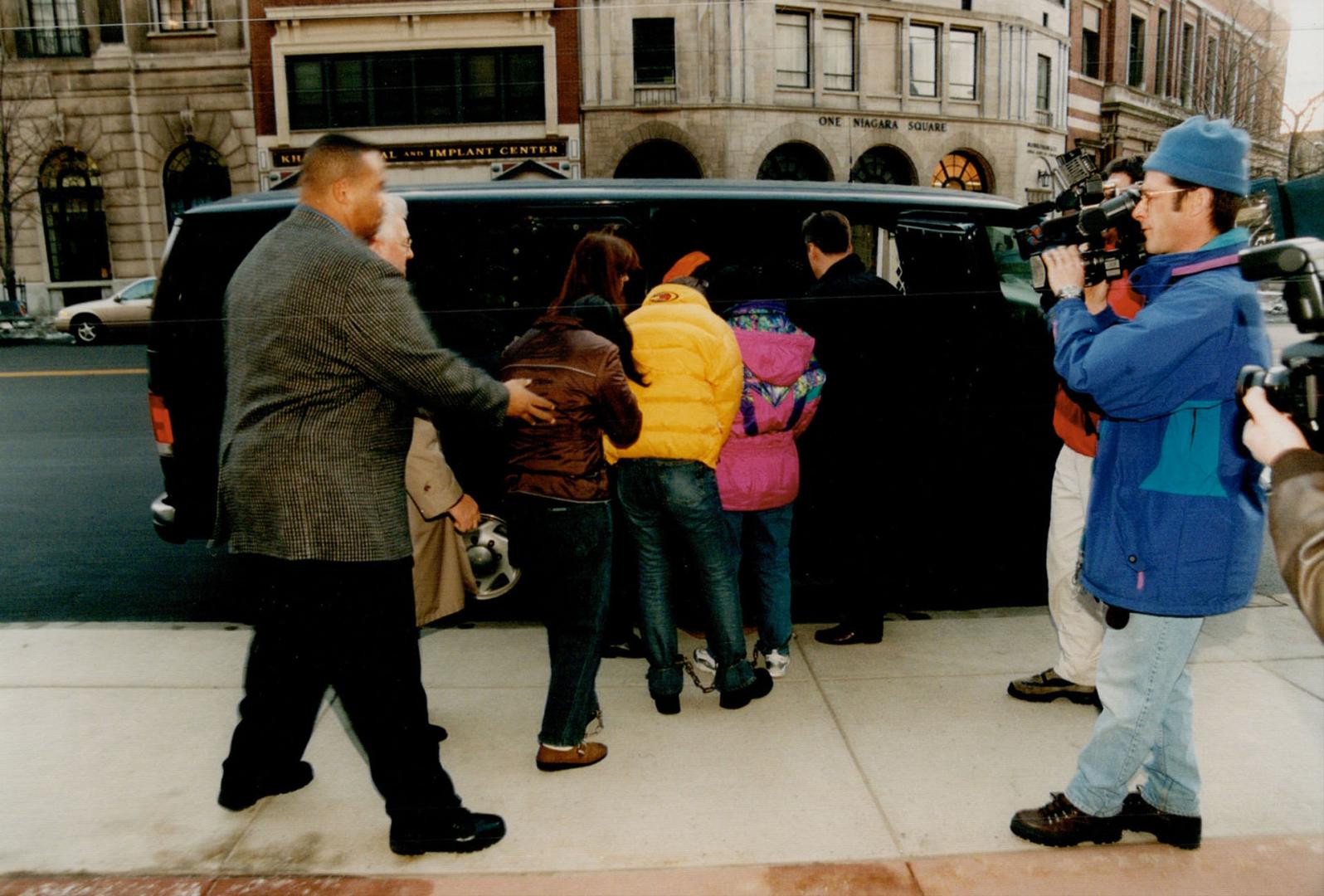 Border suspects: U.S. marshals escort Chinese nationals from a Buffalo courthouse after they were remanded in custody yesterday. They are alleged to have tried to enter the U.S. illegally