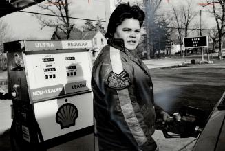 Marion Hill (right), 19, pumps gas at the new variety store