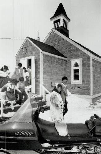 Cree wedding: Newly married, Gloria Masty and Edward Kawapit leave Kuujjuarapik's Anglican church, one of the few places in the village where Inuit and Cree share the same space