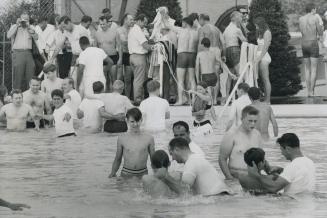 At Mass Baptism of Jehovah's Witnesses in Sunnyside Pool today, some of the 500 new members of the sect receive the total immersion which is a keyston(...)