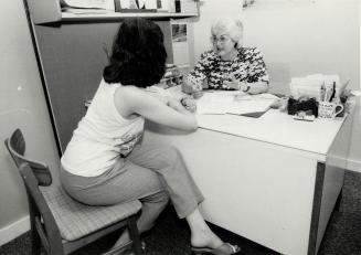 Friend in need: Encama Escovar, right, assists client who needs help finding a place to live, just one of the many problems handled by the Bloor Information and Legal Services clinic