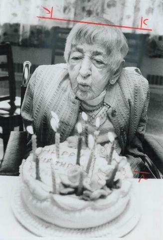 Mrs. Cryer blows out the candles at her birthday party yesterday