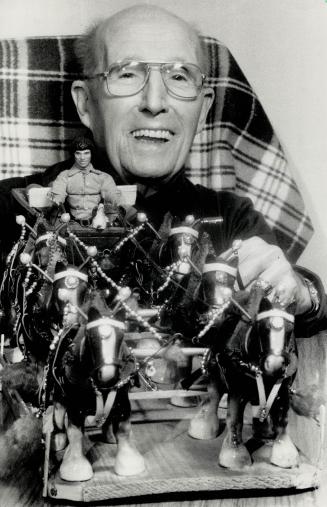 Unbridled enjoyment: William Clark, 90, who makes intricate leather harnesses for ceramic horses as a hobby, poses with his pride and joy -- a six-horse team complete with wagon