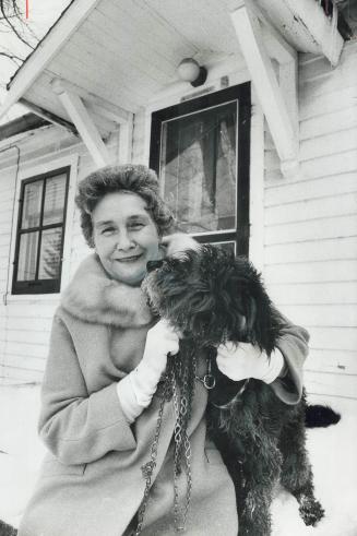 Evelyn Archibald, a 64-year-old Chatham widow who won $480,000 in the Irish Sweepstakes yesterday, takes her son's terrier, Terry, for a walk. She pla(...)