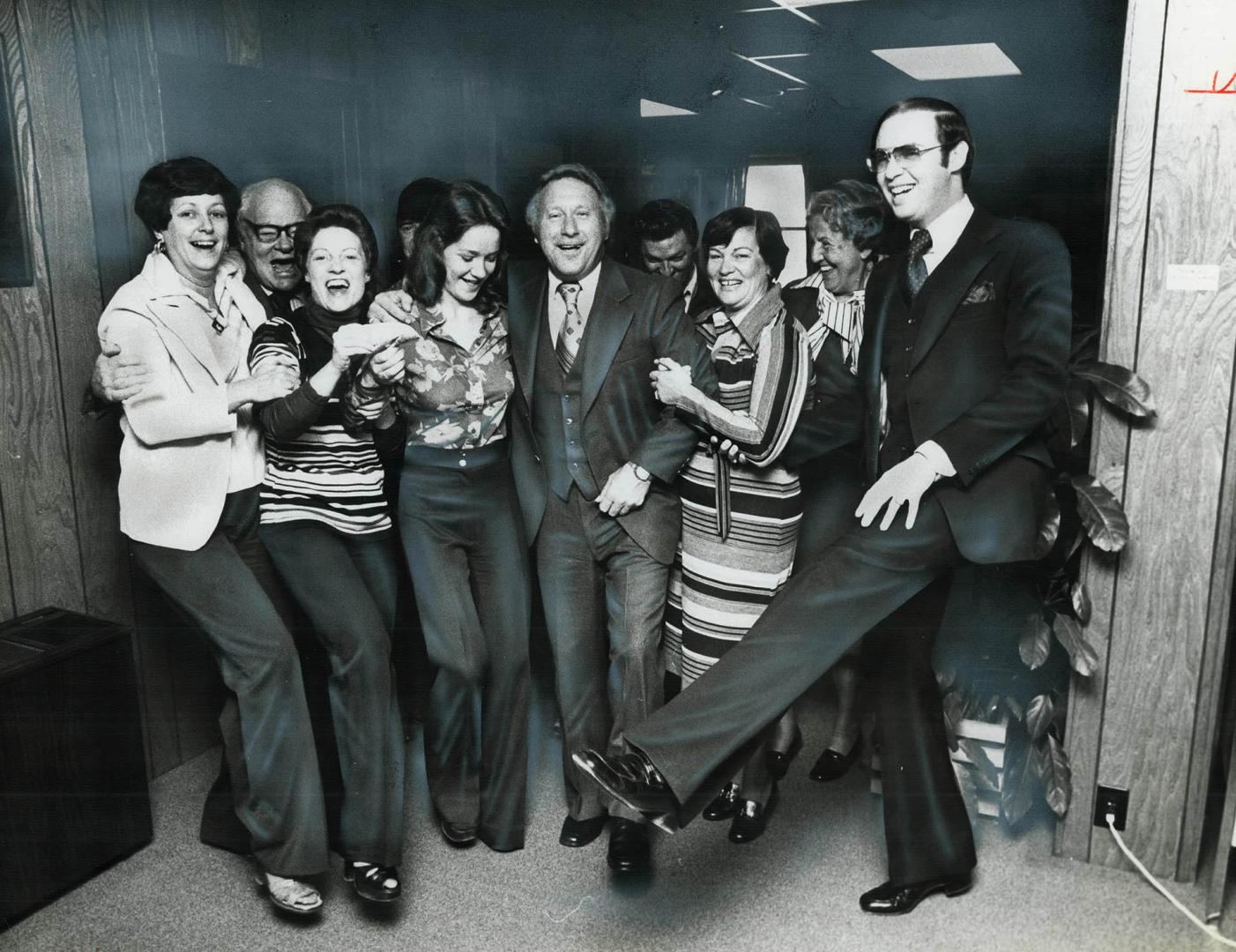 Nine of the 10 winners who share in the $1 million winning Provincial lottery ticket dance with their boss, Frank Dempsey (second from left). From lef(...)