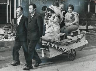 Bridal ride in a pushcart-built-for-four, It wasn't the most elegant vehicle a bride has everridden in on her way to her wedding reception, but for ne(...)